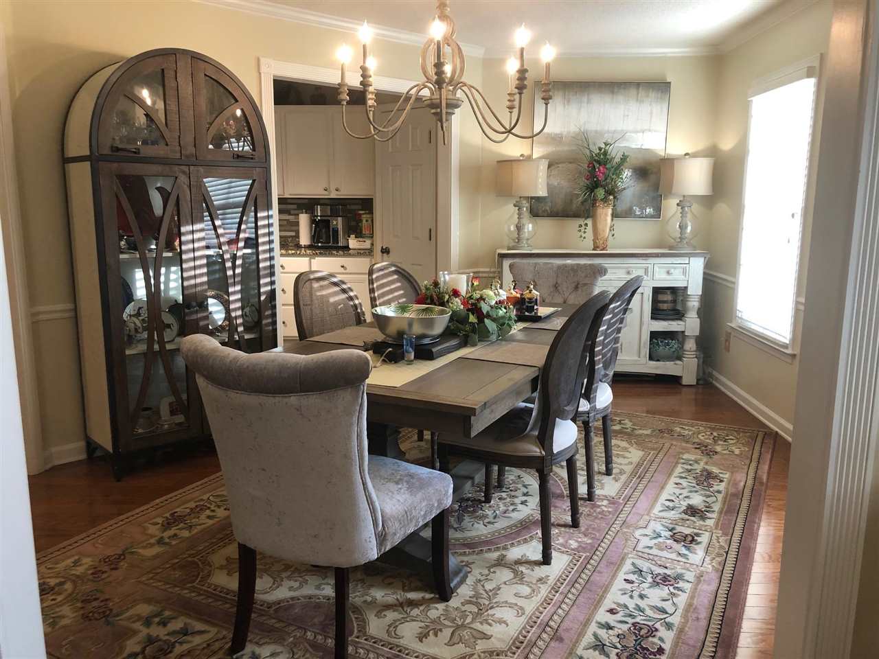 9114 Raspberry Lane Cordova, TN 38016 - Photo 3 of 22 a dining room with furniture a rug and wooden floor