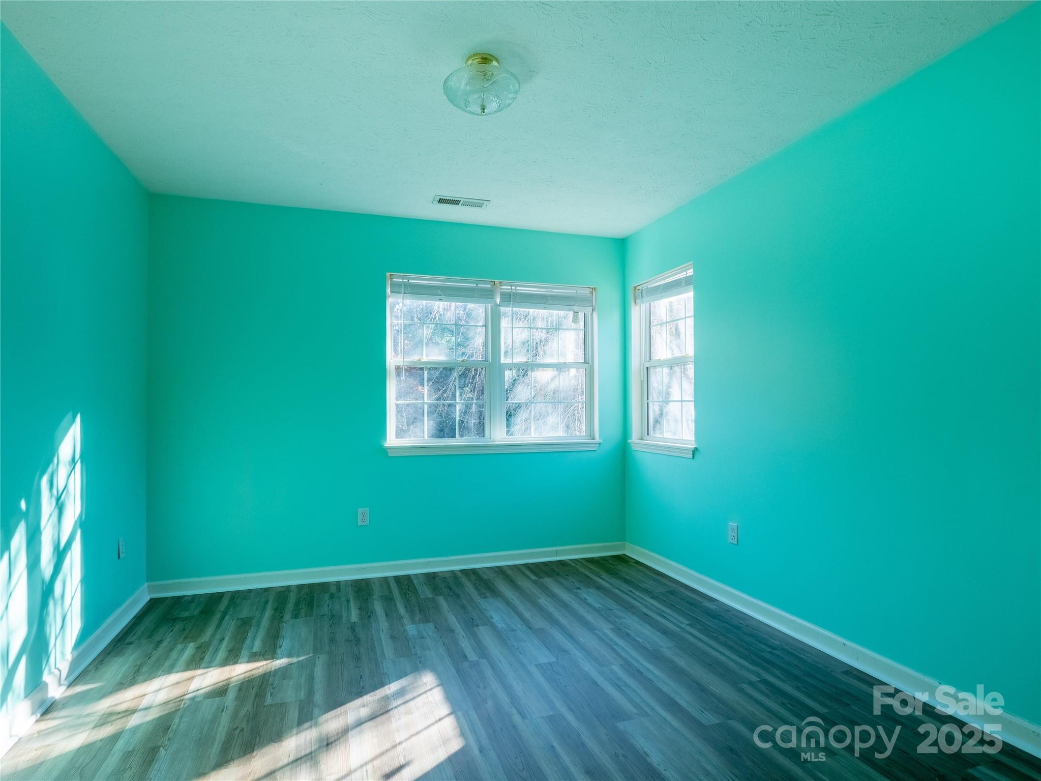 488 Oleta Road Hendersonville, NC 28792 - Photo 18 of 27 an empty room with wooden floor and windows