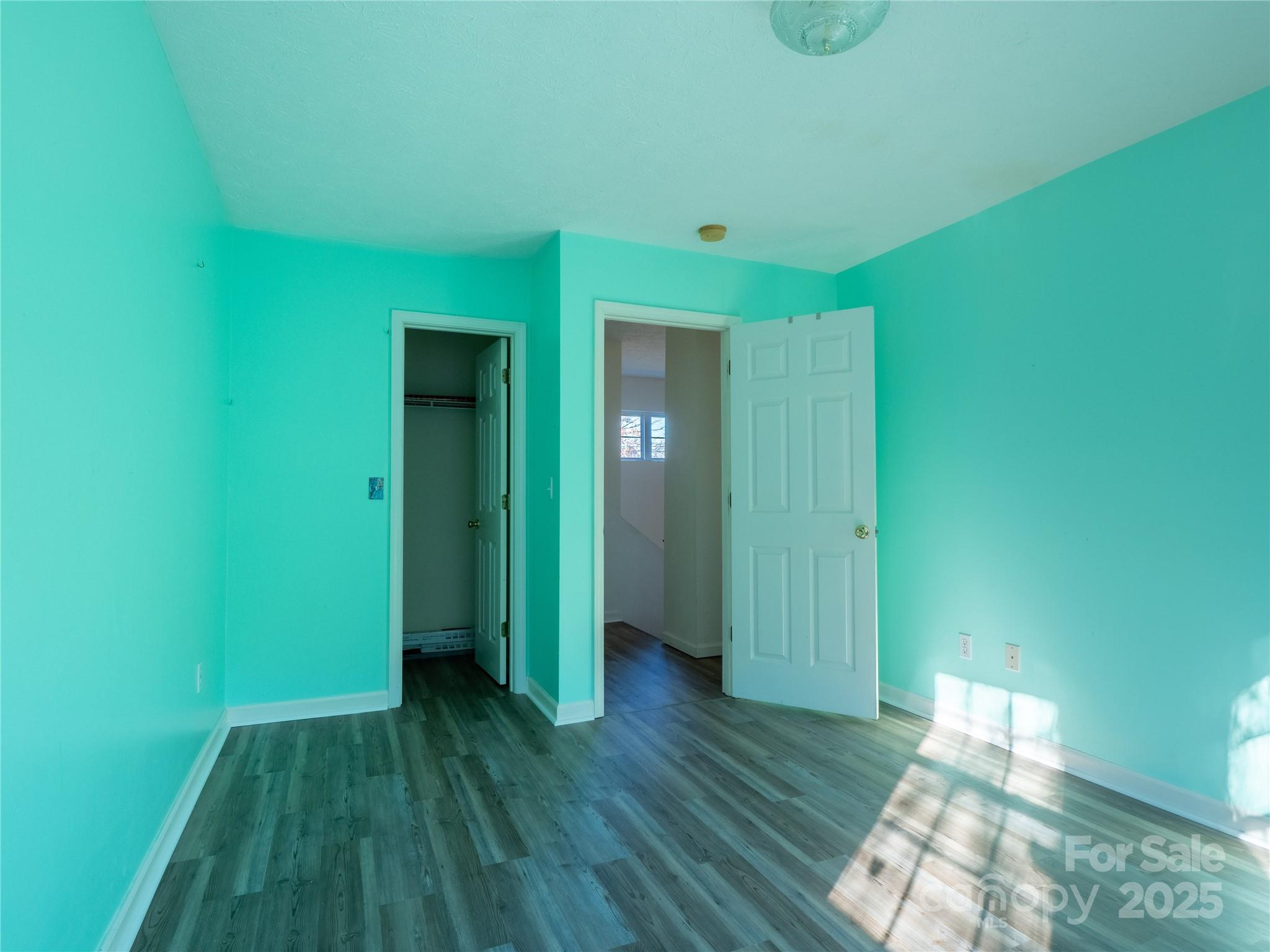 488 Oleta Road Hendersonville, NC 28792 - Photo 19 of 27 a view of an empty room with closet and wooden floor