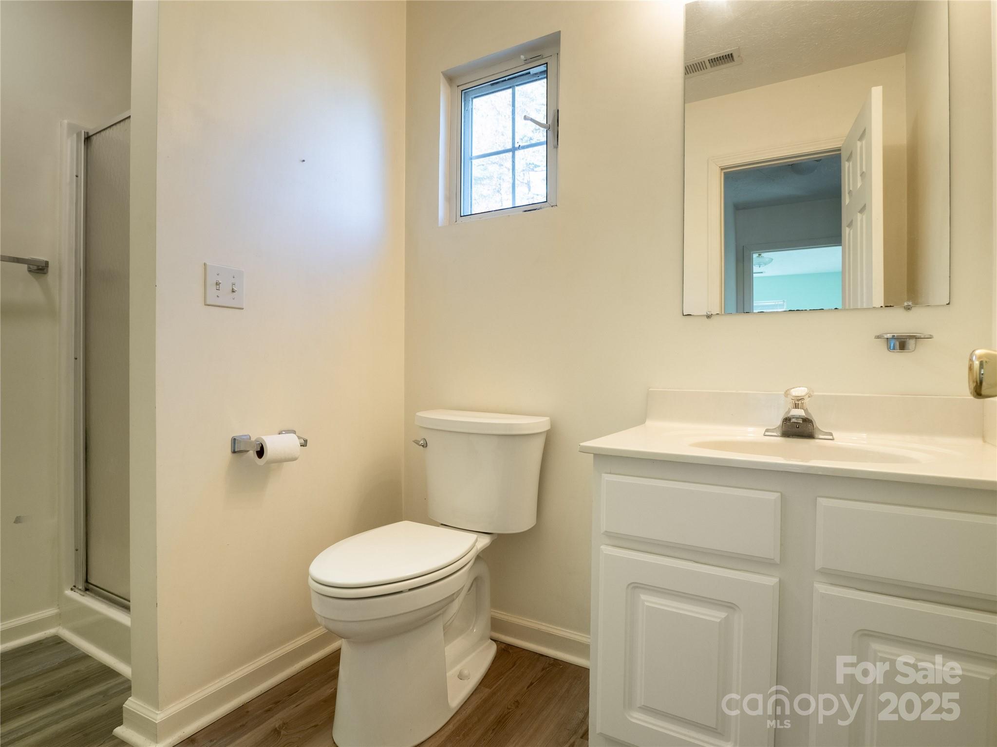488 Oleta Road Hendersonville, NC 28792 - Photo 20 of 27 a bathroom with a toilet a sink and mirror