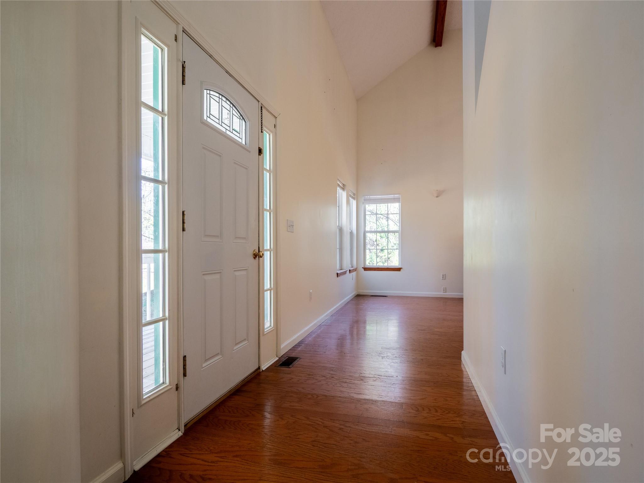 488 Oleta Road Hendersonville, NC 28792 - Photo 2 of 27 a view of a hallway with wooden floor and windows