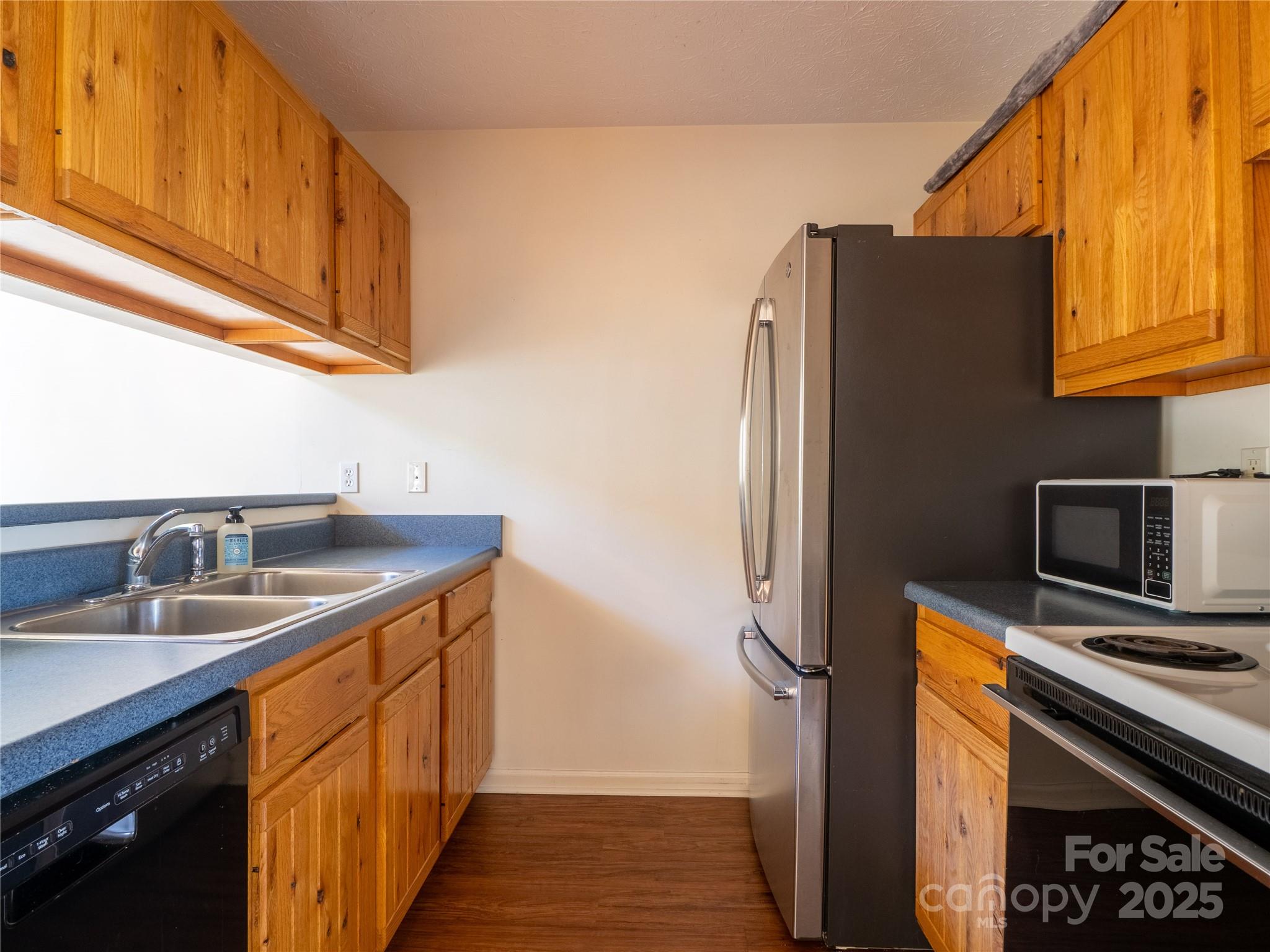 488 Oleta Road Hendersonville, NC 28792 - Photo 6 of 27 a kitchen with stainless steel appliances granite countertop a refrigerator and a sink
