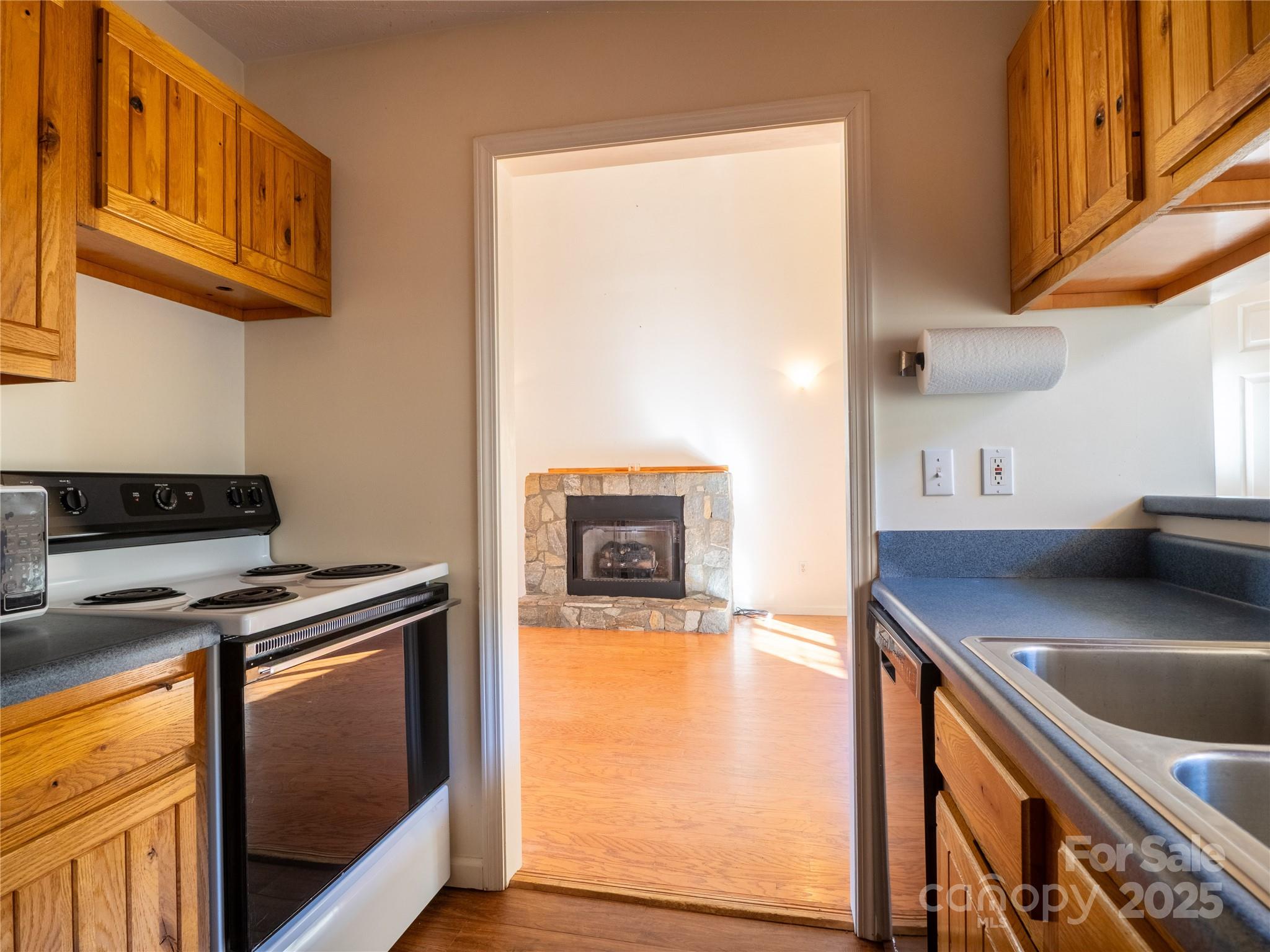 488 Oleta Road Hendersonville, NC 28792 - Photo 7 of 27 a kitchen with stainless steel appliances granite countertop a sink a stove and a microwave