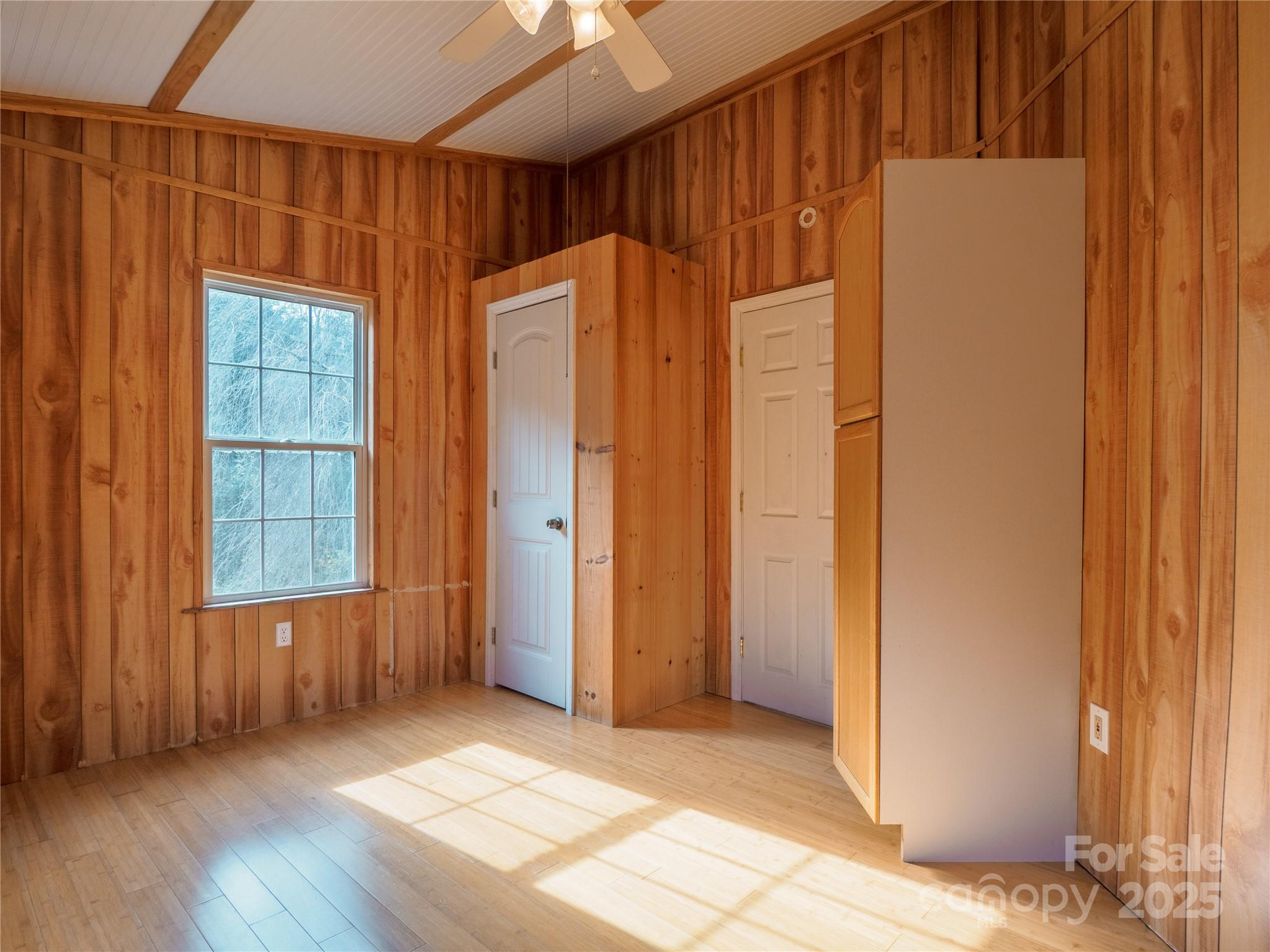 488 Oleta Road Hendersonville, NC 28792 - Photo 9 of 27 an empty room with wooden floor and windows
