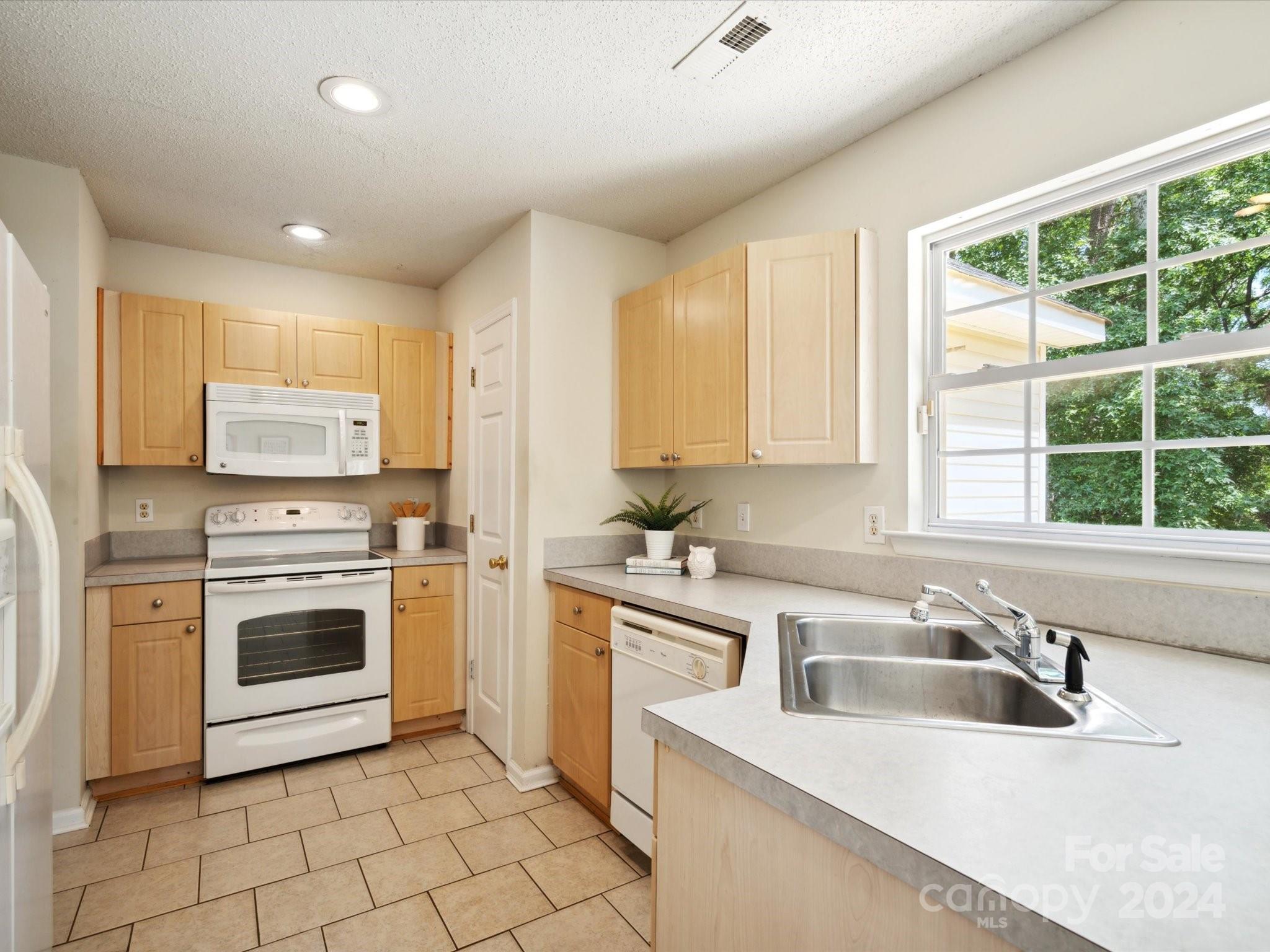2113 River Chase Drive Monroe, NC 28110 - Photo 12 of 36 a kitchen with a sink stove top oven and cabinets