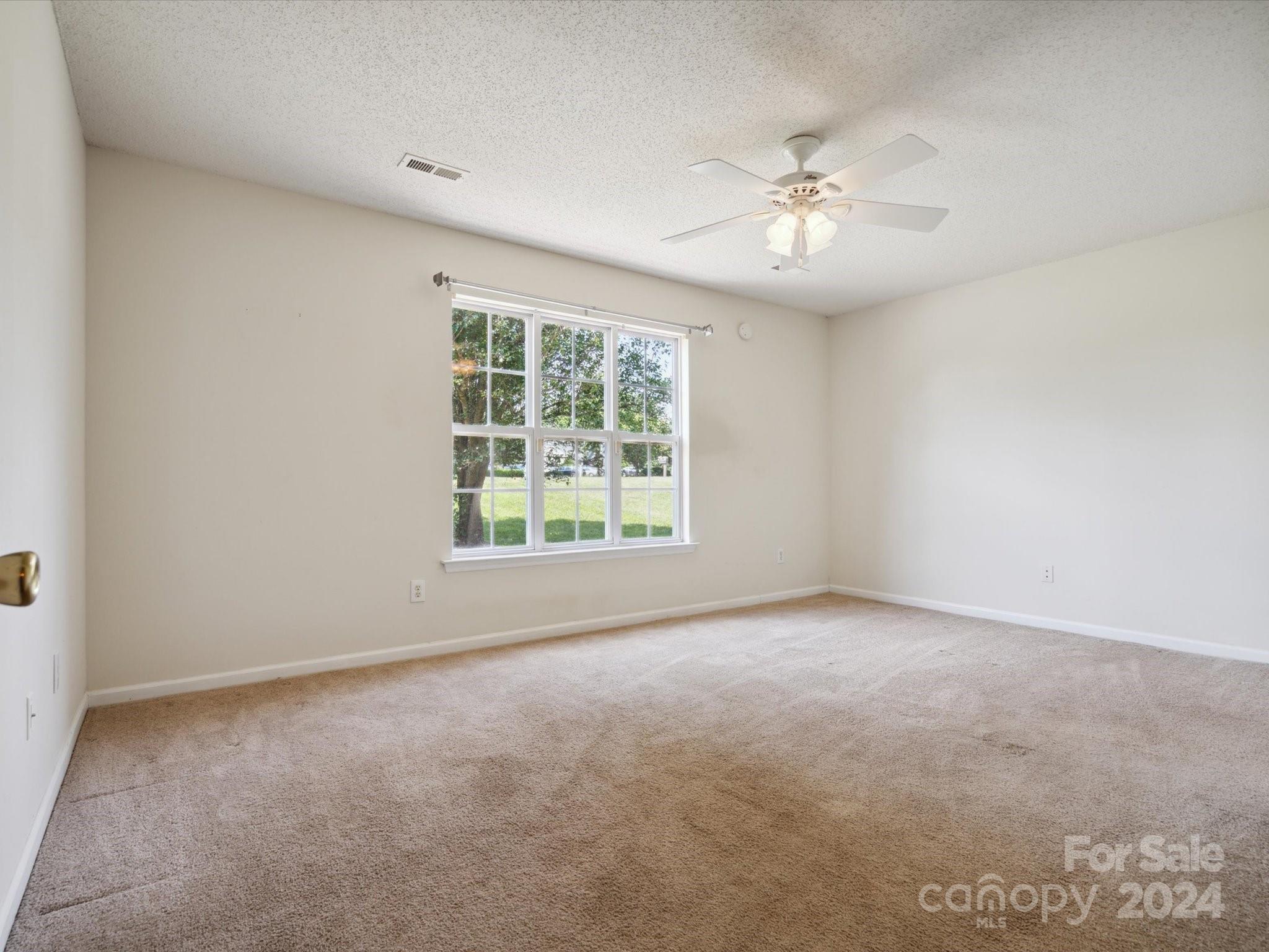 2113 River Chase Drive Monroe, NC 28110 - Photo 14 of 36 an empty room with a ceiling fan and window