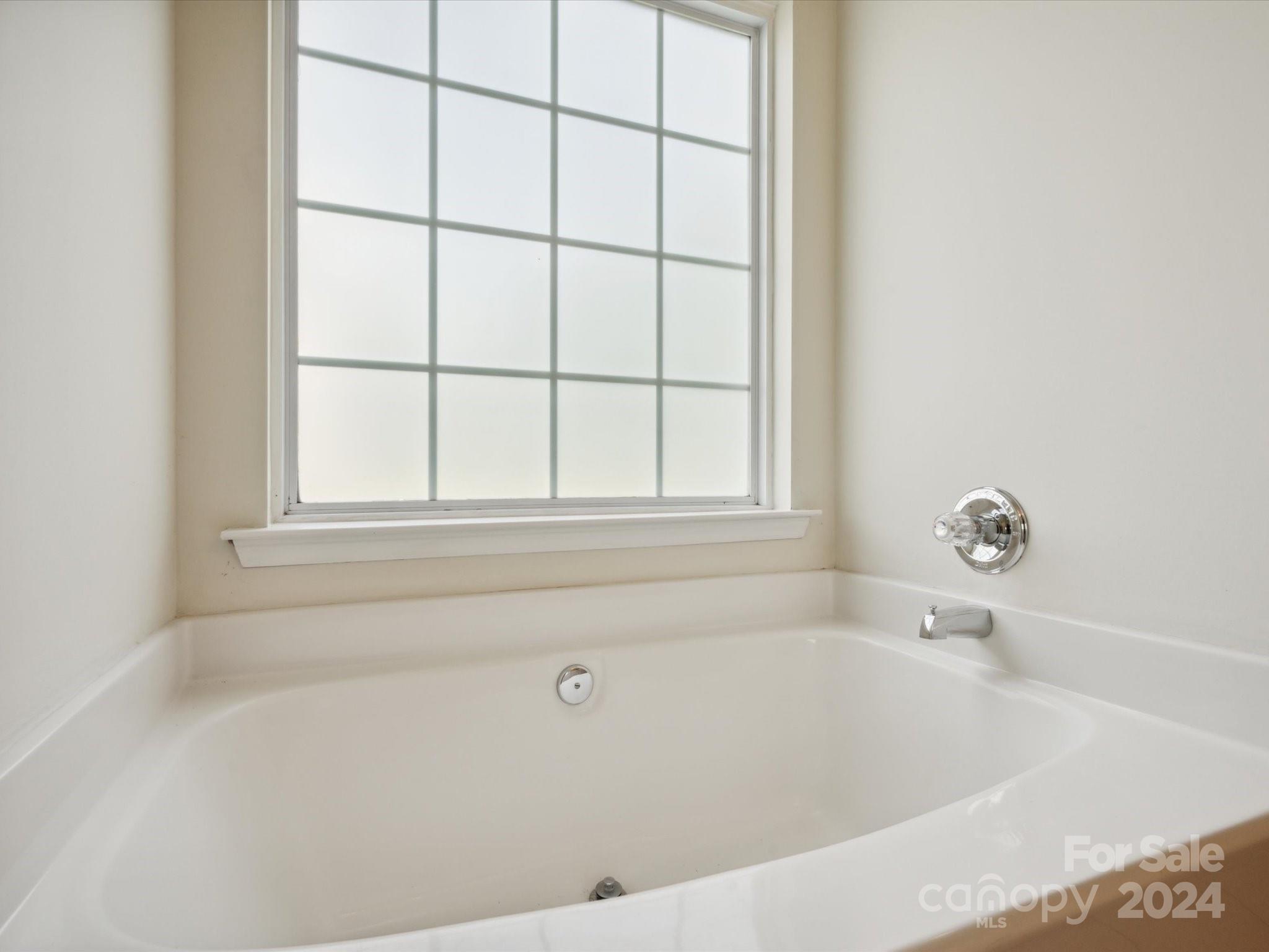 2113 River Chase Drive Monroe, NC 28110 - Photo 18 of 36 a white bath tub sitting next to a window