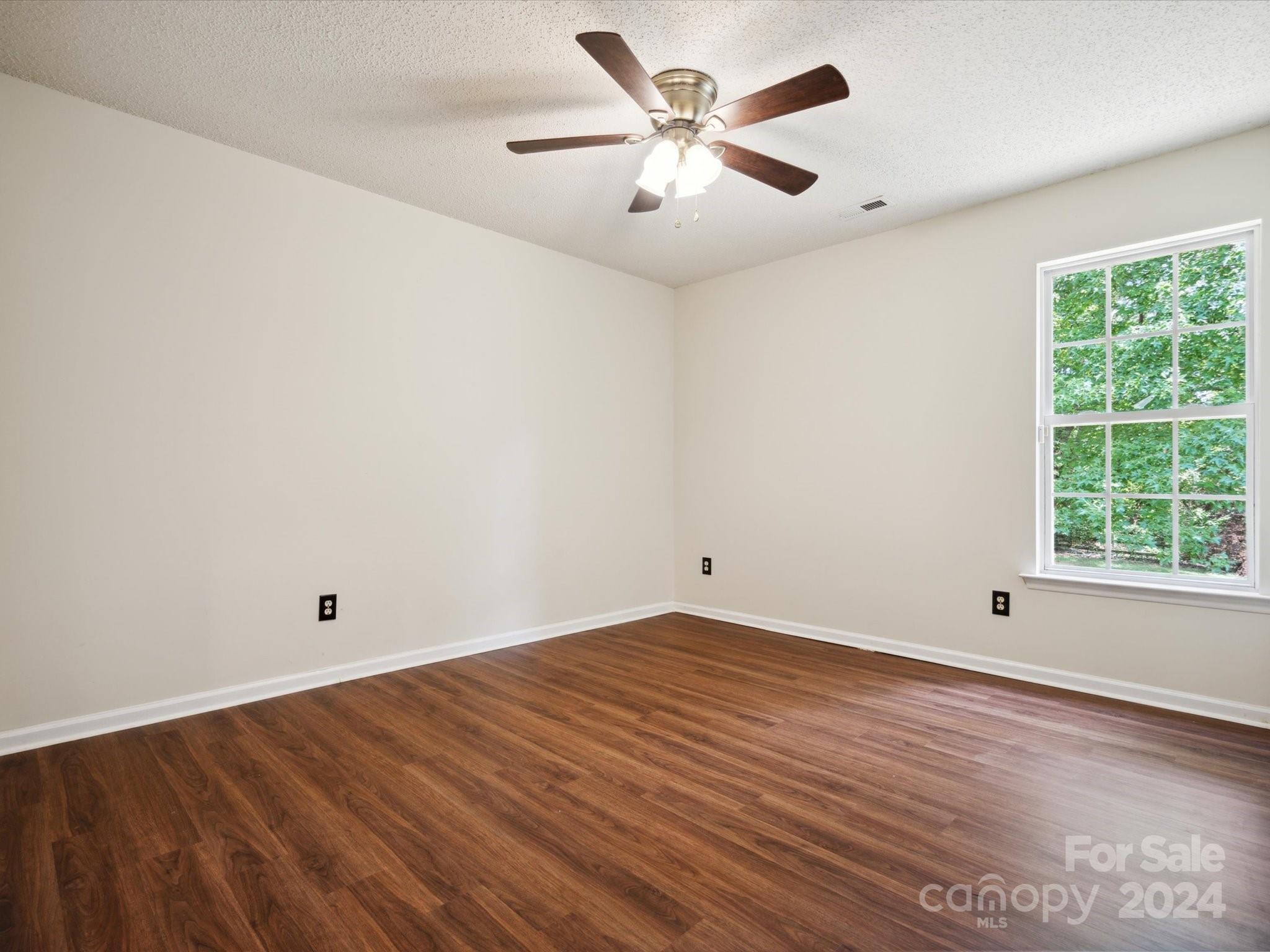 2113 River Chase Drive Monroe, NC 28110 - Photo 21 of 36 wooden floor in an empty room with a window