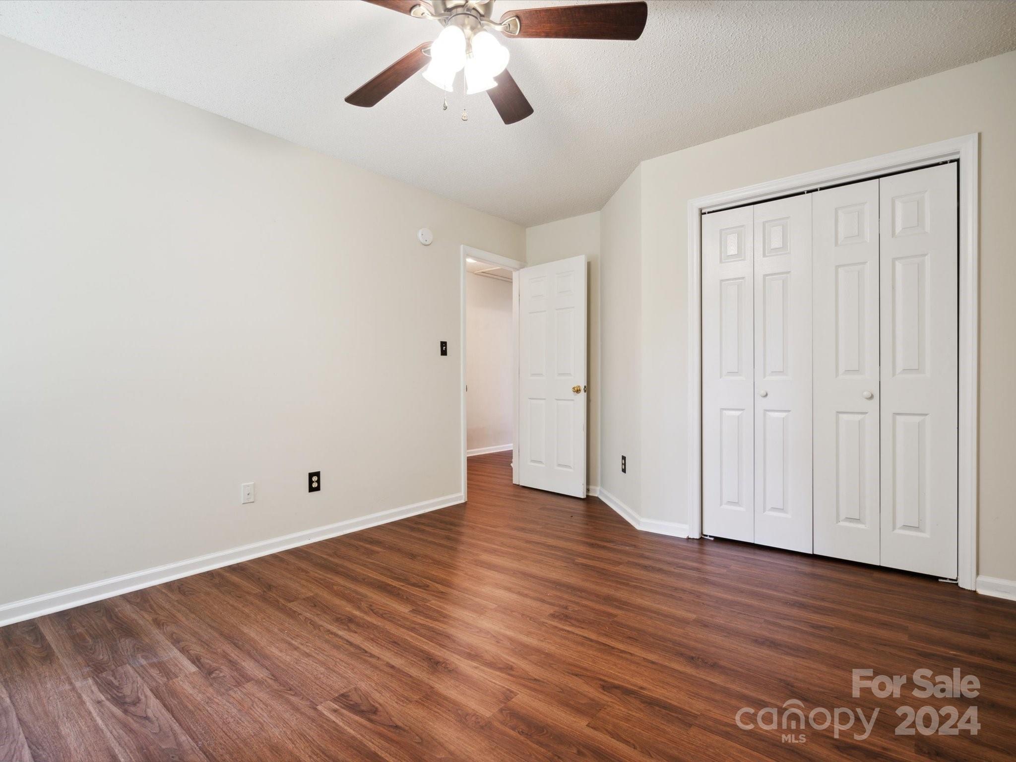 2113 River Chase Drive Monroe, NC 28110 - Photo 22 of 36 an empty room with wooden floor and windows