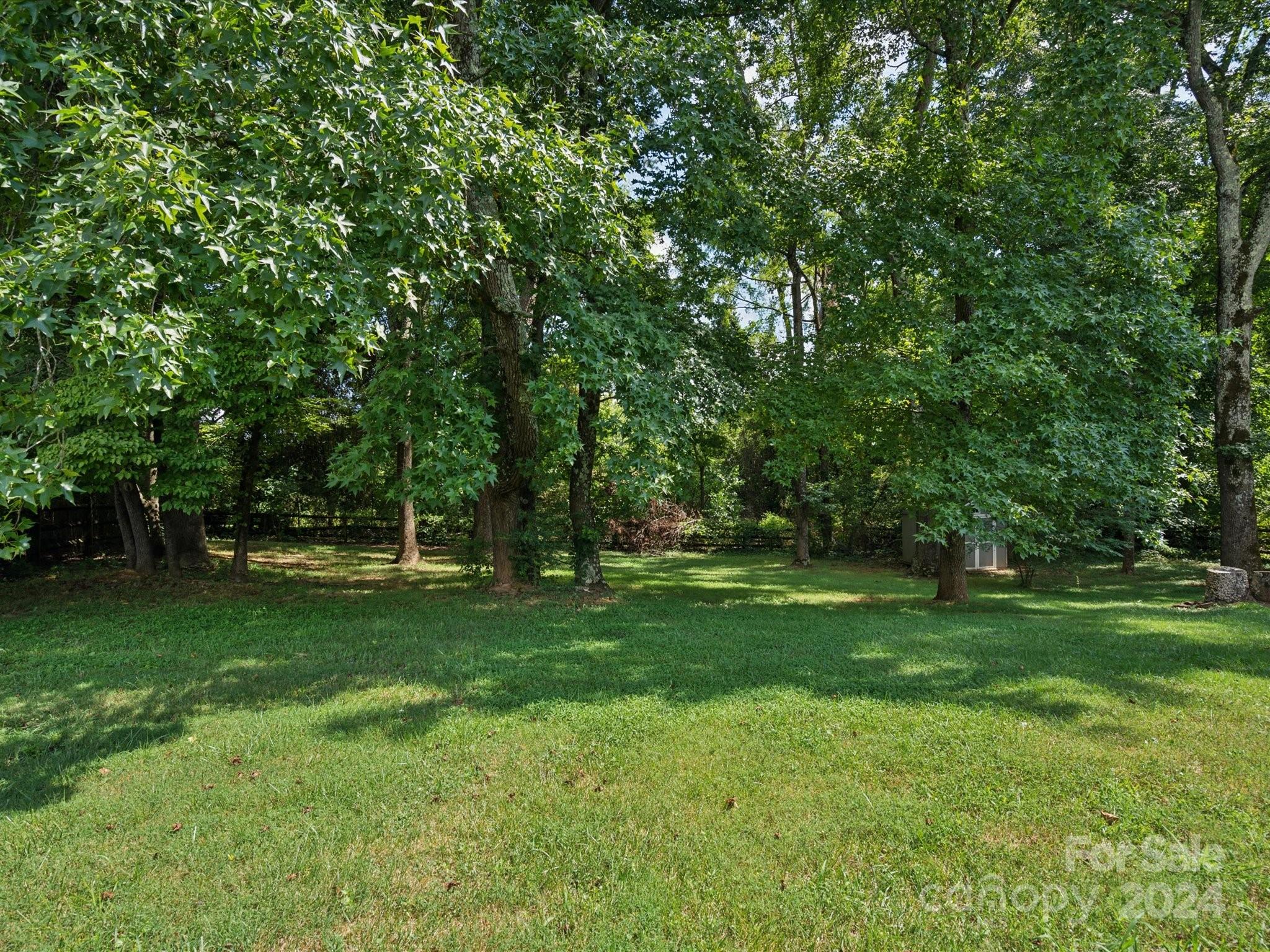 2113 River Chase Drive Monroe, NC 28110 - Photo 32 of 36 a view of a grassy field with trees