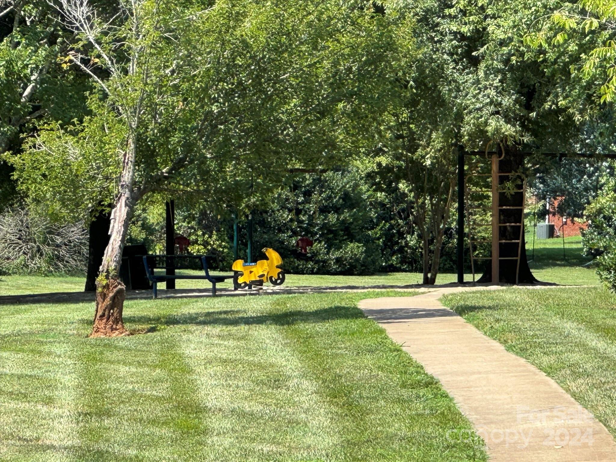 2113 River Chase Drive Monroe, NC 28110 - Photo 36 of 36 a view of a park with swings and a slide