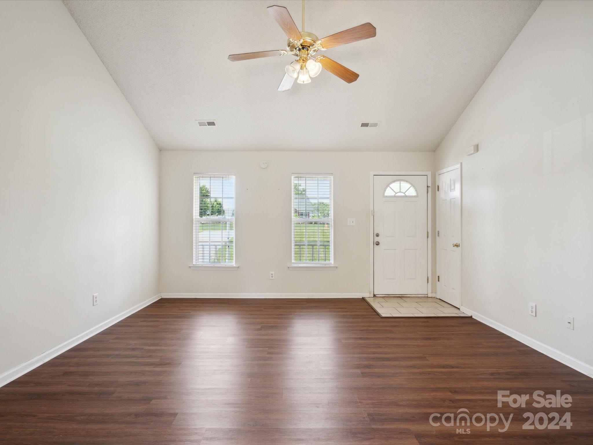 2113 River Chase Drive Monroe, NC 28110 - Photo 8 of 36 an empty room with wooden floor and windows