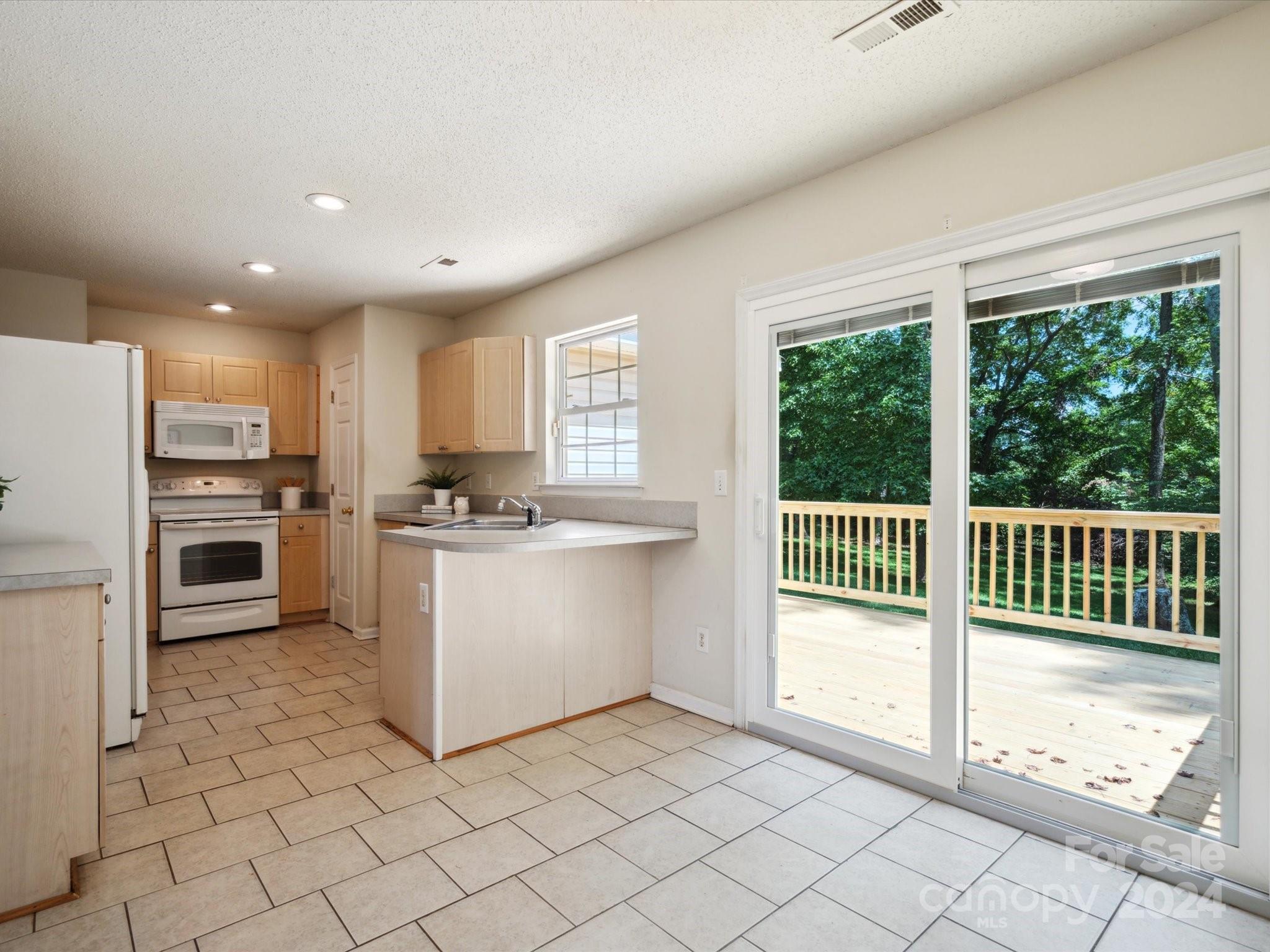 2113 River Chase Drive Monroe, NC 28110 - Photo 9 of 36 a kitchen with a refrigerator and a sink