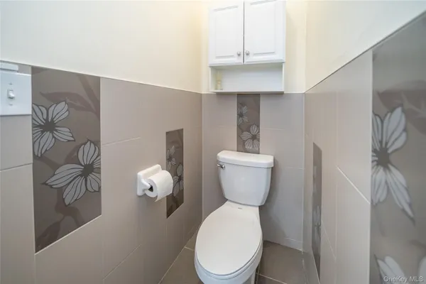 a white toilet sitting next to a shower