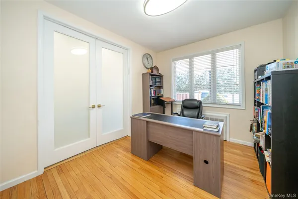 a work space with wooden floor and windows