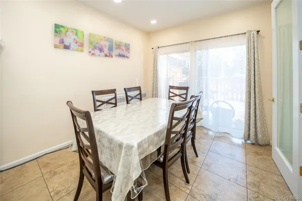 a view of a dining room with furniture and a window