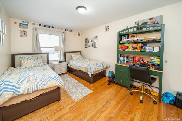 a bedroom with two beds and a window