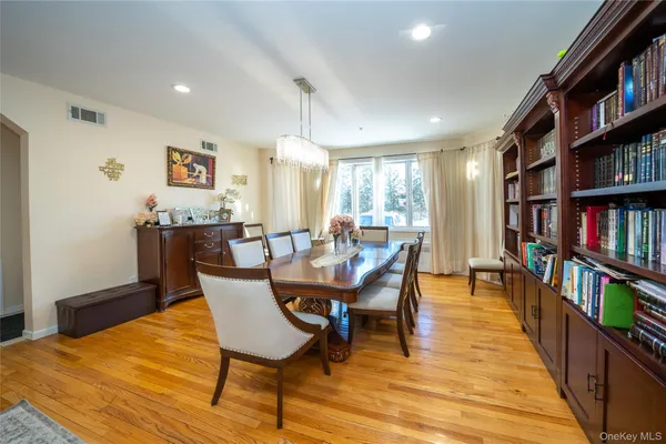 a dining room with furniture and a book shelf