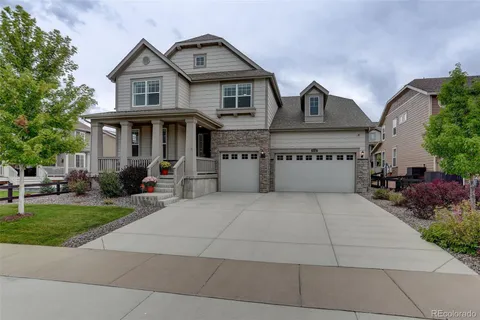 a front view of a house with a yard and a garage