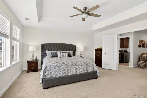 a bedroom with a bed a couch and dresser