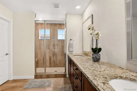 a bathroom with a granite countertop sink and a mirror
