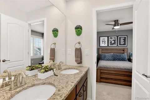 a bathroom with double vanity sinks and a bathtub