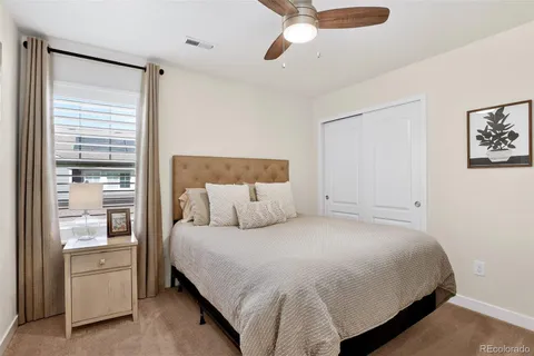 a bedroom with a bed and ceiling fan