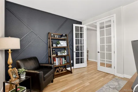 a living room with furniture and a book shelf