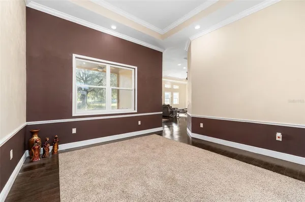 a view of room with a ceiling fan and wooden floor