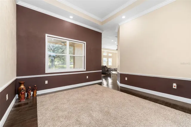 a view of room with a ceiling fan and wooden floor