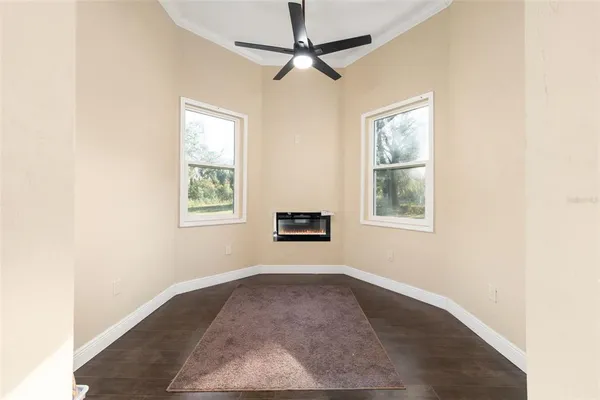 a spacious bedroom with a bed and a flat screen tv