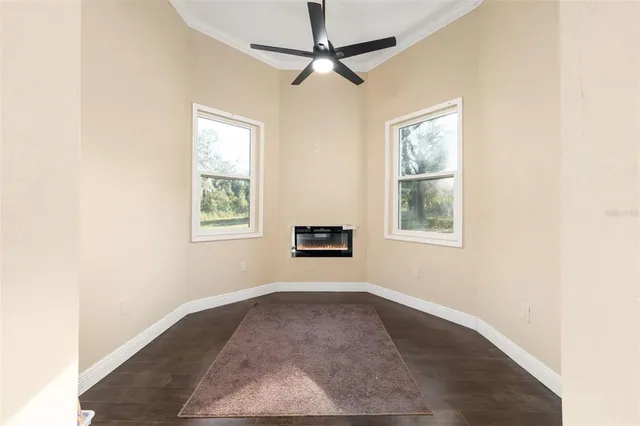 a spacious bedroom with a bed and a flat screen tv