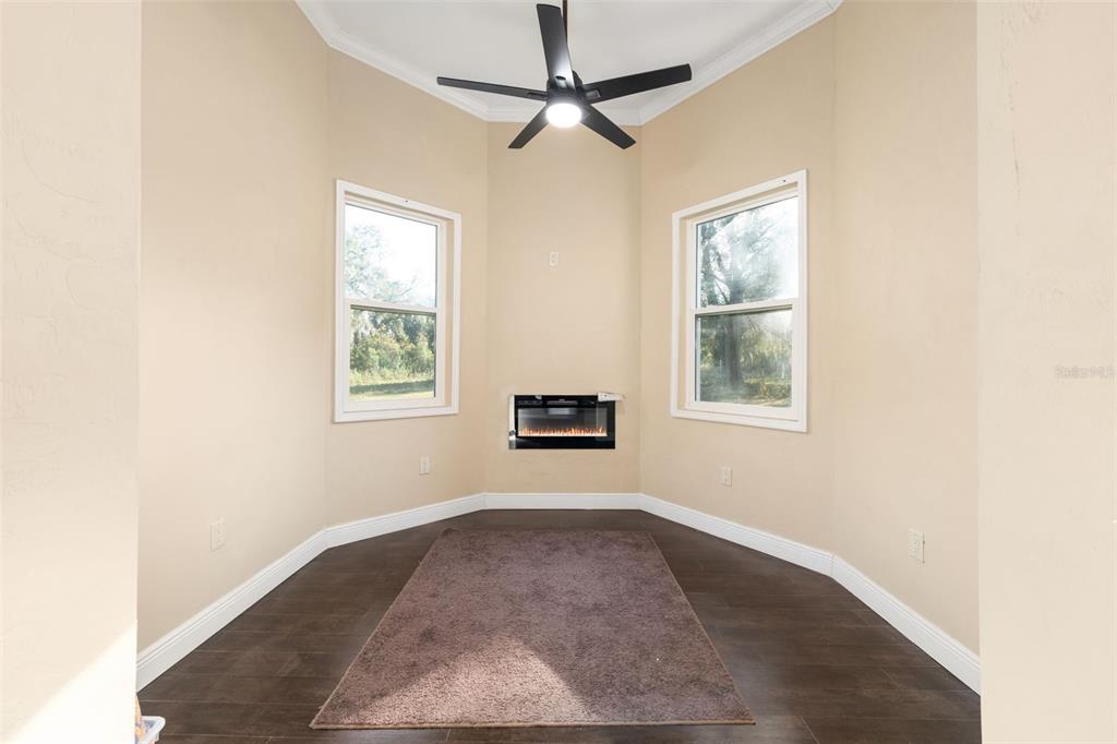 16635 Southwest 139th Avenue Archer, FL 32618 - Photo 18 of 48 an empty room with windows and fan