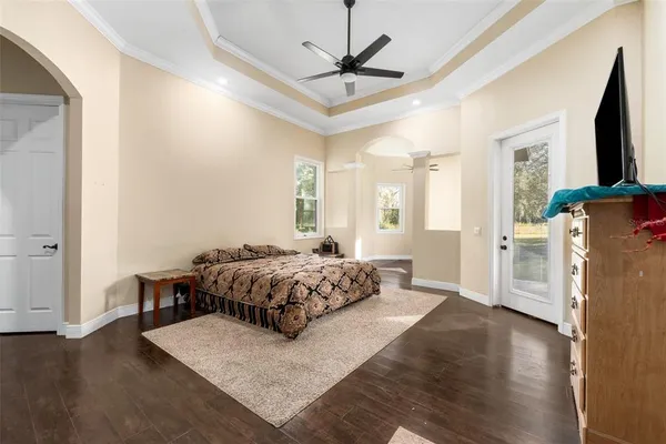a bedroom with furniture and a flat screen tv
