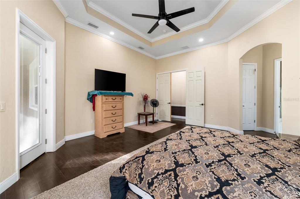 16635 Southwest 139th Avenue Archer, FL 32618 - Photo 20 of 48 a bedroom with furniture and a flat screen tv