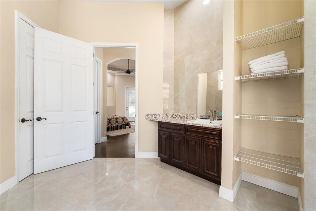 16635 Southwest 139th Avenue Archer, FL 32618 - Photo 23 of 48 a bathroom with a sink and a large mirror