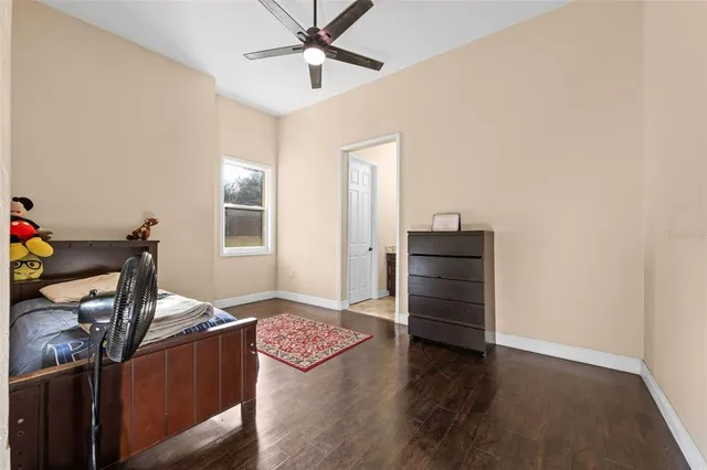a bedroom with a bed and a dresser in it