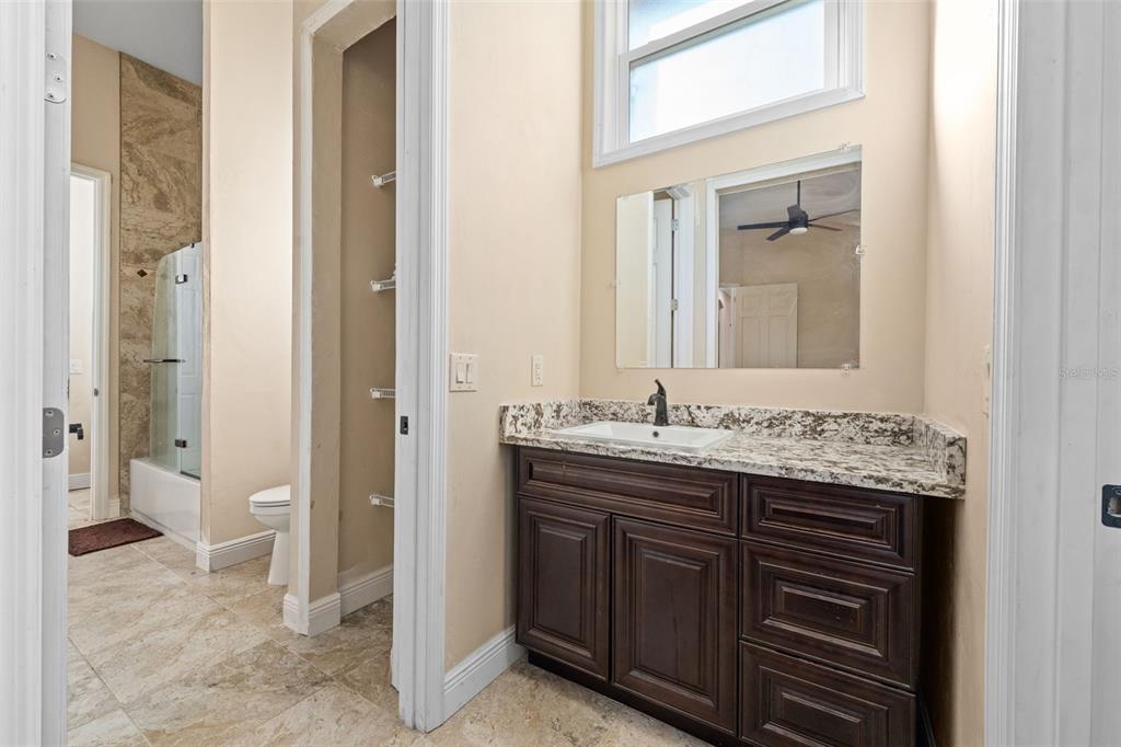 16635 Southwest 139th Avenue Archer, FL 32618 - Photo 27 of 48 a bathroom with a granite countertop sink and a mirror