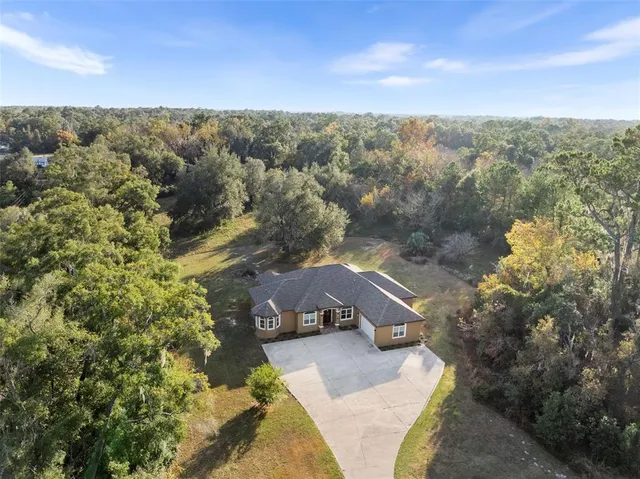 a living room with furniture a flat screen tv and a window