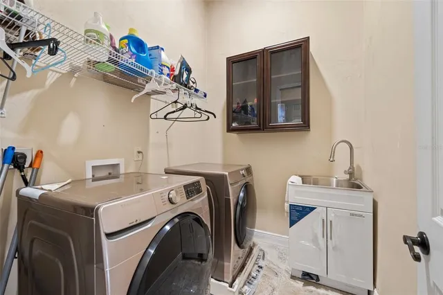a view of a hallway with a chandelier fan and windows