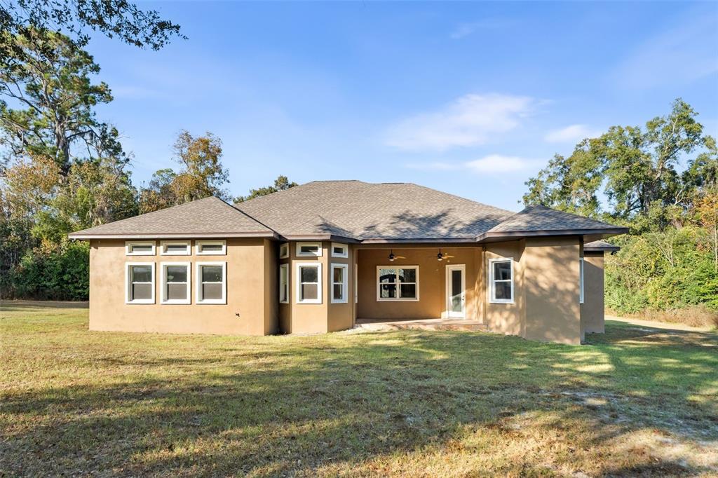 16635 Southwest 139th Avenue Archer, FL 32618 - Photo 36 of 48 a front view of a house with a garden