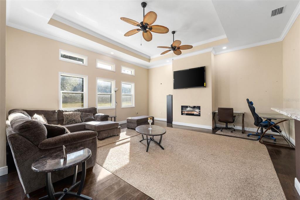 16635 Southwest 139th Avenue Archer, FL 32618 - Photo 4 of 48 a living room with furniture a flat screen tv and a window