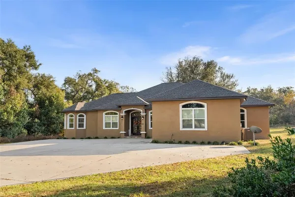 a aerial view of a house next to a yard