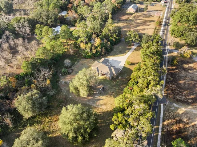 an aerial view of residential houses with outdoor space