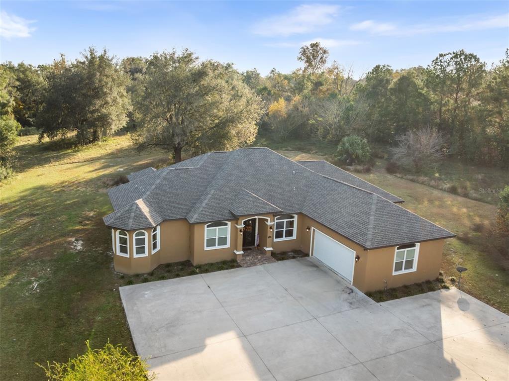 16635 Southwest 139th Avenue Archer, FL 32618 - Photo 43 of 48 a aerial view of a house next to a yard