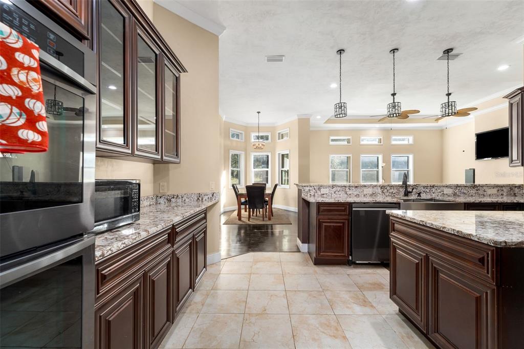 16635 Southwest 139th Avenue Archer, FL 32618 - Photo 10 of 48 a kitchen with stainless steel appliances granite countertop a stove and a sink