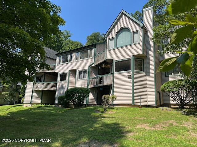 324 Hollow Road, Unit 325 East Stroudsburg, PA 18302 - Photo 1 of 17 a front view of a house with a yard and garage