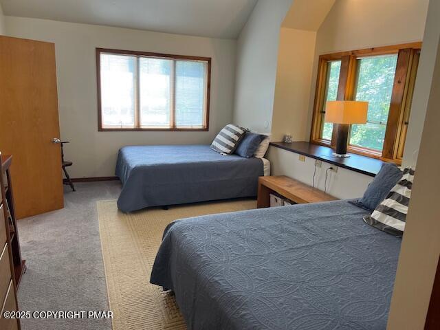 324 Hollow Road, Unit 325 East Stroudsburg, PA 18302 - Photo 13 of 17 a bedroom with two beds and a dresser next to a window