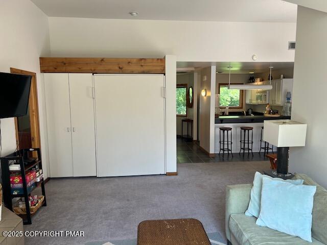 324 Hollow Road, Unit 325 East Stroudsburg, PA 18302 - Photo 10 of 17 a living room with furniture a flat screen tv and a refrigerator