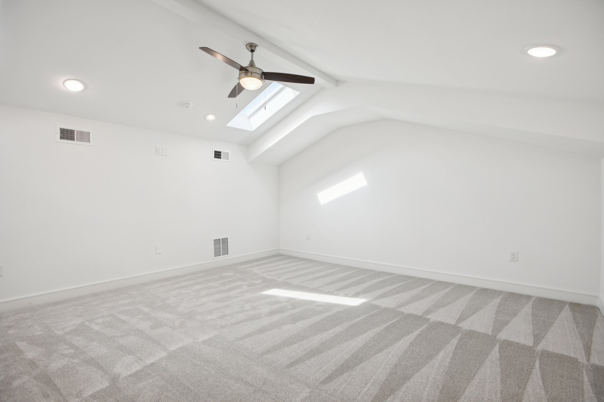 202 Tesla Circle Austin, TX 78681 - Photo 35 of 35 Additional living space featuring a ceiling fan, a skylight, light colored carpet, recessed lighting, and beam ceiling